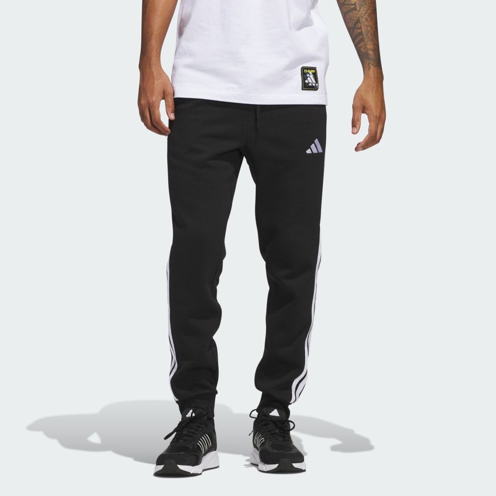 adidas Essentials 3-Stripes Fleece Pants in neutral colorway, featuring signature three-stripe branding down the leg