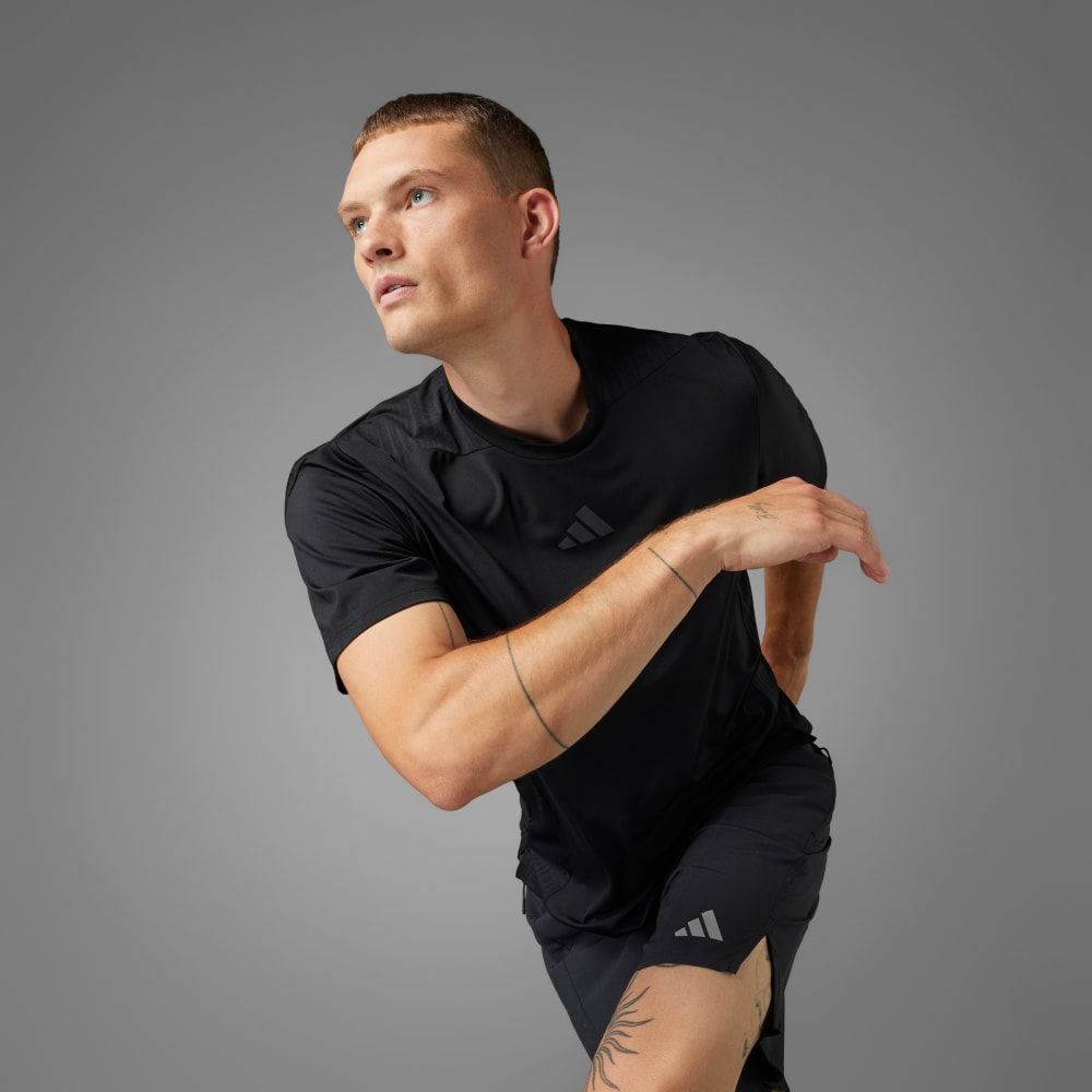adidas Designed-for-Training Intensity Tee in neutral colorway, displayed on flat surface showcasing technical fabric construction