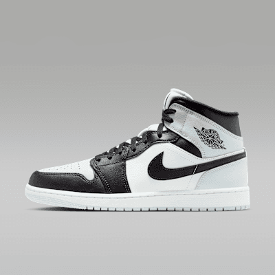 Air Jordan 1 Mid in Black/Aura/White/Squadron Blue colorway, side profile view showing mid-cut silhouette and premium leather construction