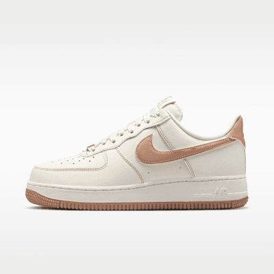 Nike Air Force 1 '07 in Sail and Rose Gold, featuring a clean leather upper with warm metallic accents on the Swoosh and heel tab